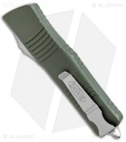 Microtech Combat Troodon OTF Knife D/E Dagger OD Green (3.8" SW Full Serr) 8 Microtech Combat Troodon OTF Knife D/E Dagger OD Green (3.8" SW Full Serr) -Microtech Microtech Combat Troodon OTF DE Dagger OD Green SW Full Serr 142 12OD BHQ 98064 jr side
