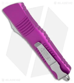 Microtech Combat Troodon OTF Knife D/E Dagger Violet (3.8" SW Full Serr) 8 Microtech Combat Troodon OTF Knife D/E Dagger Violet (3.8" SW Full Serr) -Microtech Microtech Combat Troodon OTF DE Dagger Violet SW Full Serr BHQ 98068 jr side