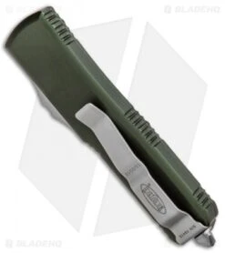 Microtech UTX-85 D/E OTF Automatic Knife OD Green (3.125" Satin Full Serr) 8 Microtech UTX-85 D/E OTF Automatic Knife OD Green (3.125" Satin Full Serr) -Microtech Microtech UTX 85 DE OTF Auto OD Green Satin Serr Full 232 6OD BHQ 90985 jr side